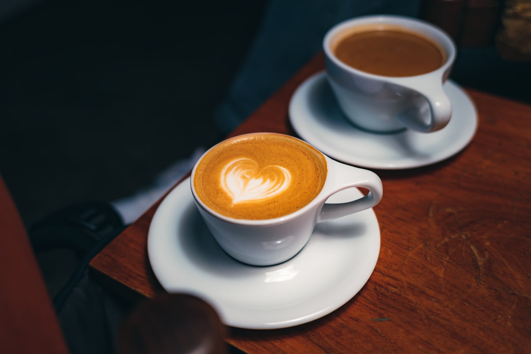 Two beautiful cups of coffee on wooden table
